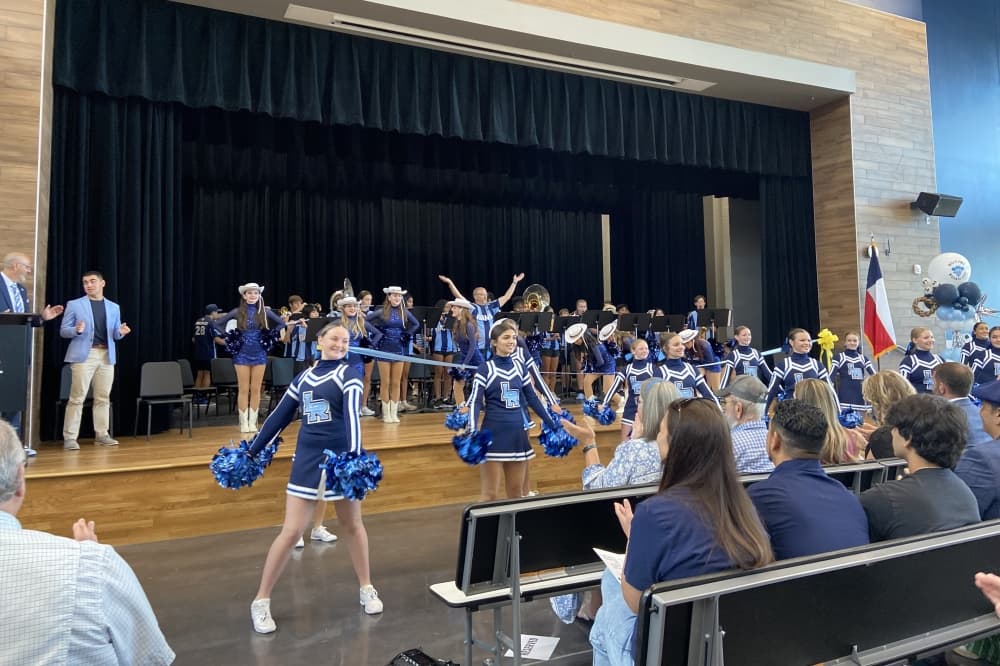 Cheerleaders dance with the band