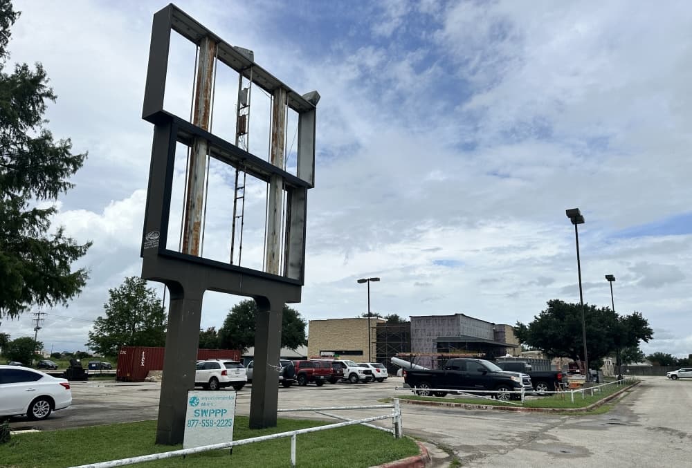 The exterior is shown from a distance with a shell of where the sign will be in the foreground.