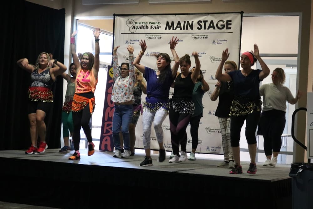A group dances on a stage.