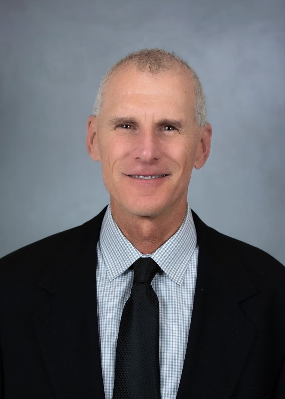 Headshot of a male wearing a suit. 