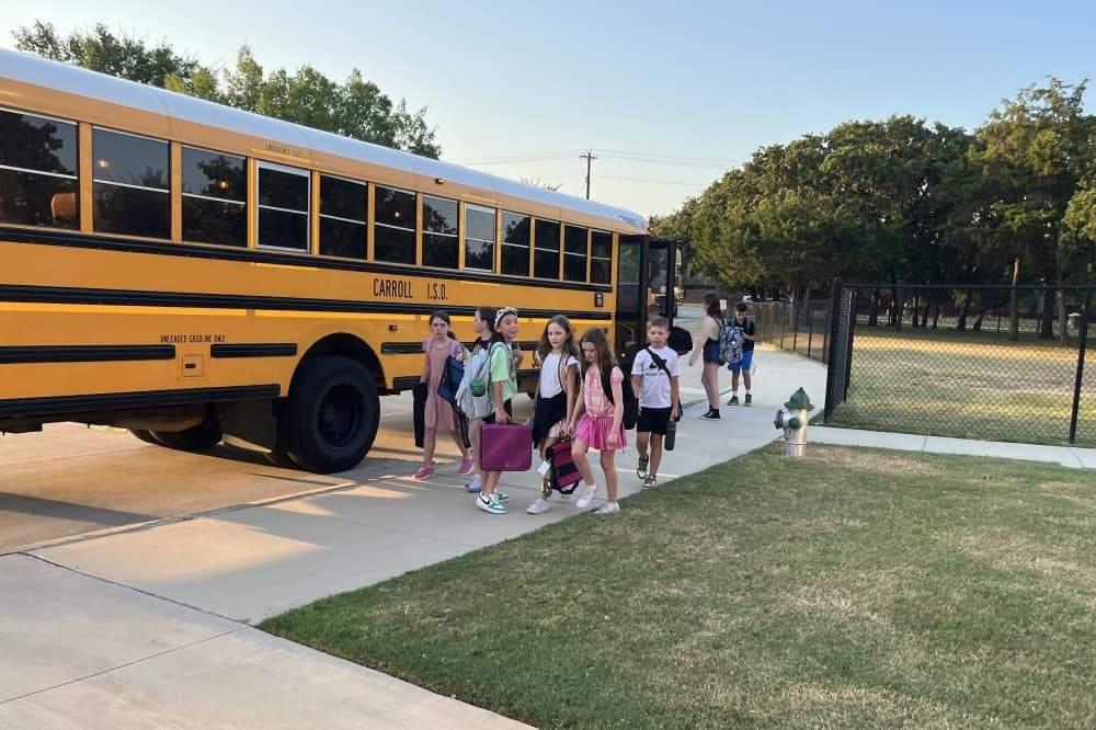 Students get off school bus
