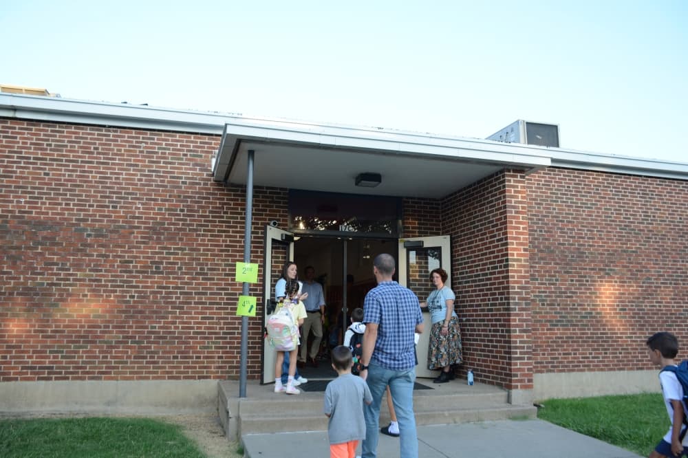Campus staff greet students as they prepare to enter Lake Highlands Elementary School for the first day of school Aug. 13. 