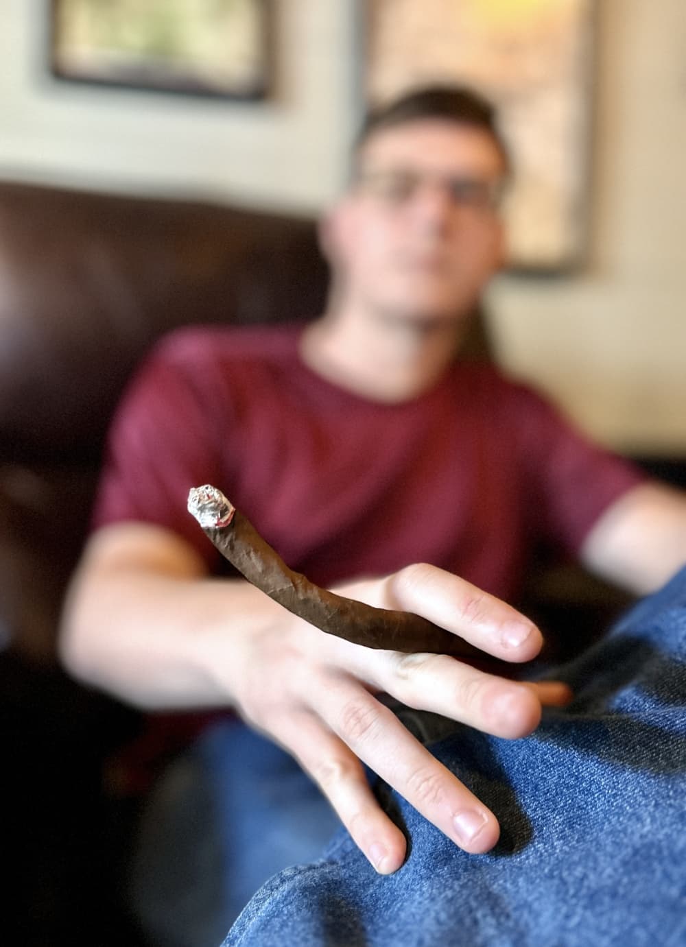 A person holds one of the three pieces of the Turducken while sitting in the lounge.