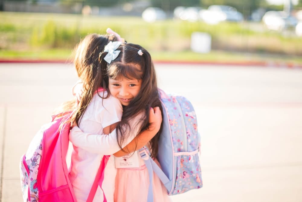 Students hug each other on their first day back at Peters Colony Elementary School Aug. 13. (Courtesy Lewisville ISD)