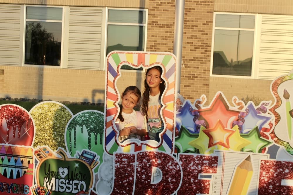 Students pose behind a photo prop at Jane Ruestmann Elementary school Aug. 14. (Don Munsch/Community Impact)