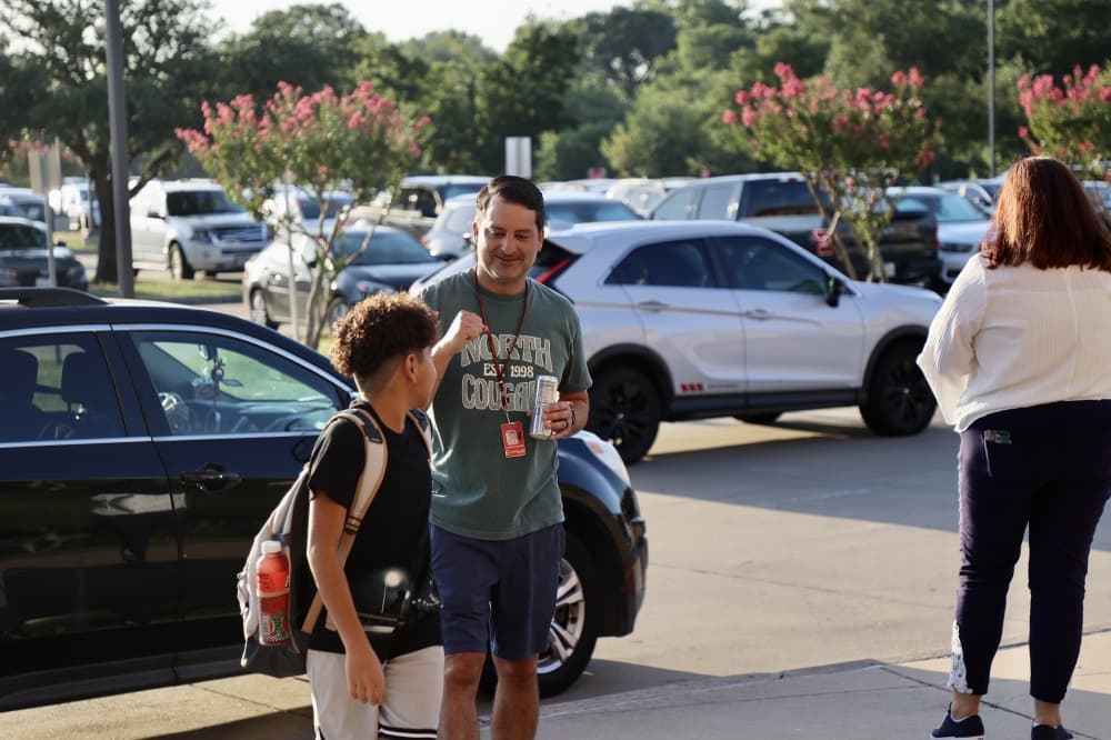 District staff greets students as they exit their vehicles at Coppell Middle School North. (Courtesy Coppell ISD)