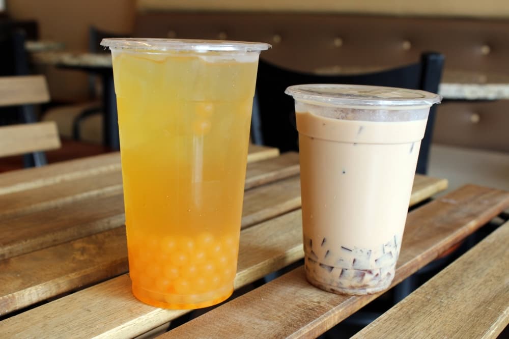 Popular drink options include peach green tea with peach popping boba and classic milk tea with coffee jelly boba.  (Karen Chaney/Community Impact)