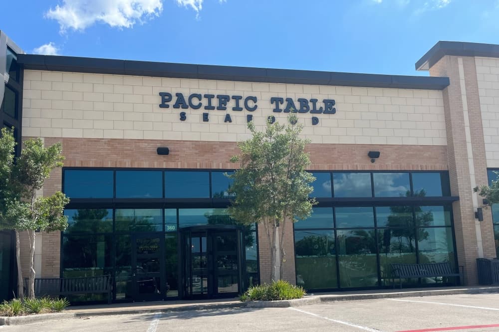 Exterior of a building with Pacific Table signage. 