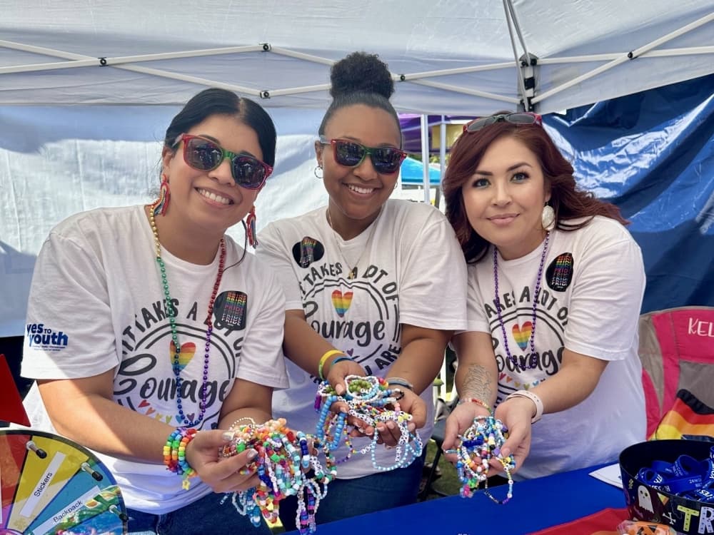 pride festival attendees holding bracelets 