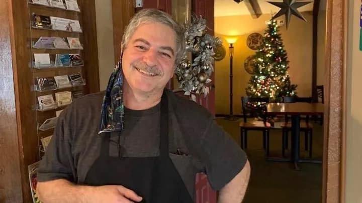 Khalil poses for a photo during Christmastime inside the restauraunt.
