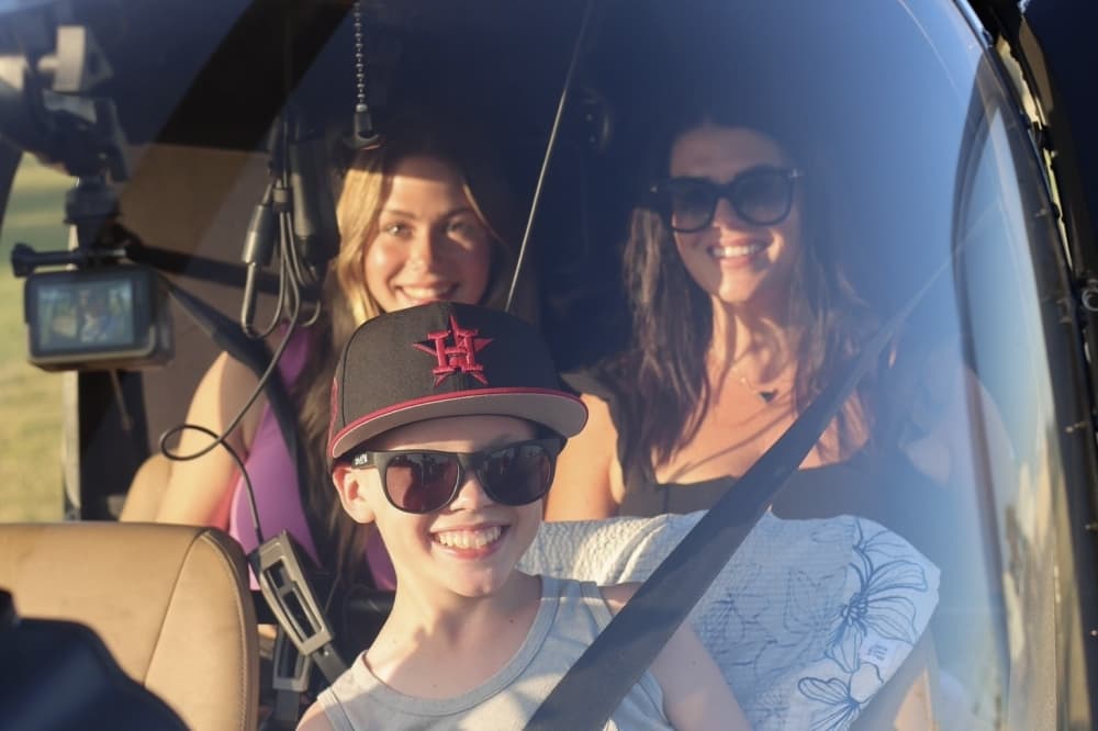 child with family in helicopter 