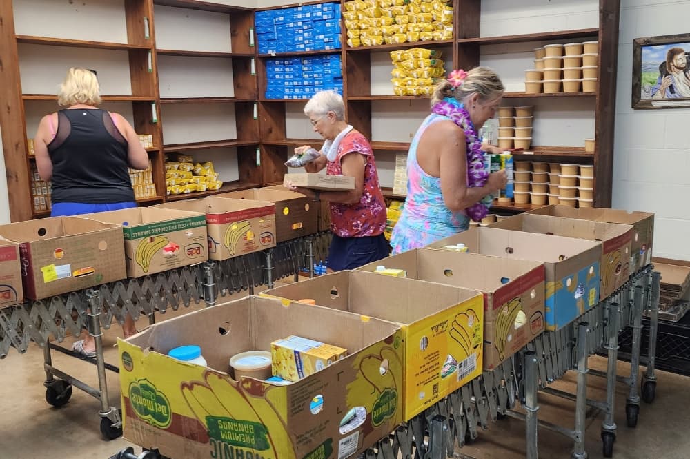 Volunteers packaging boxes