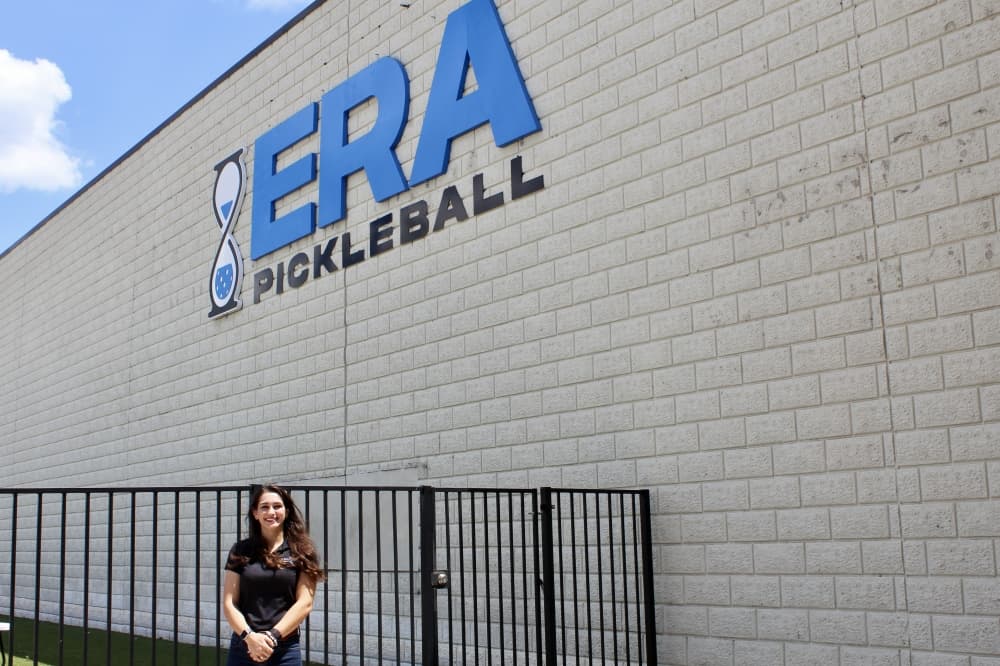 owner in front or Era sign 
