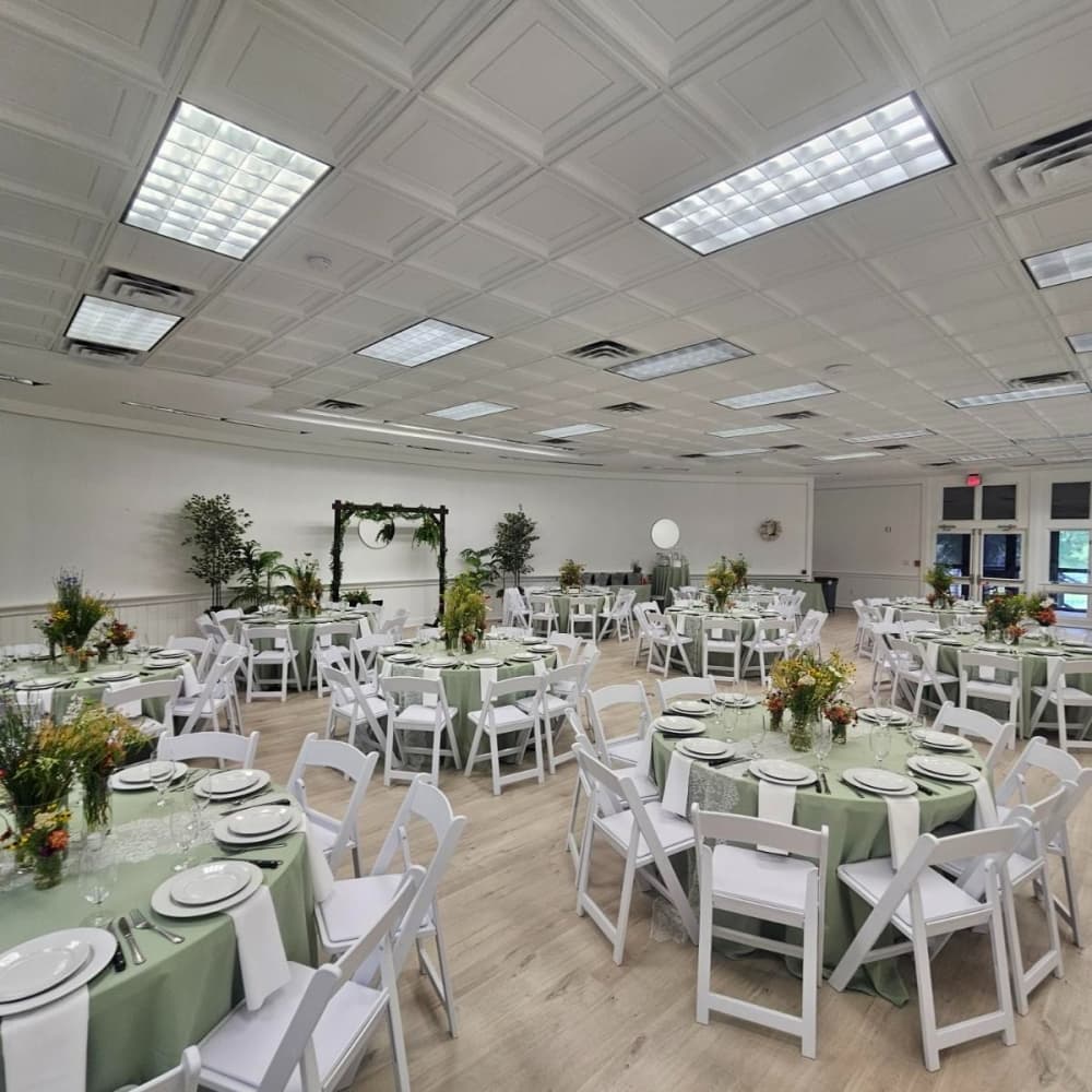 The white indoor dining area is shown with accents of green.