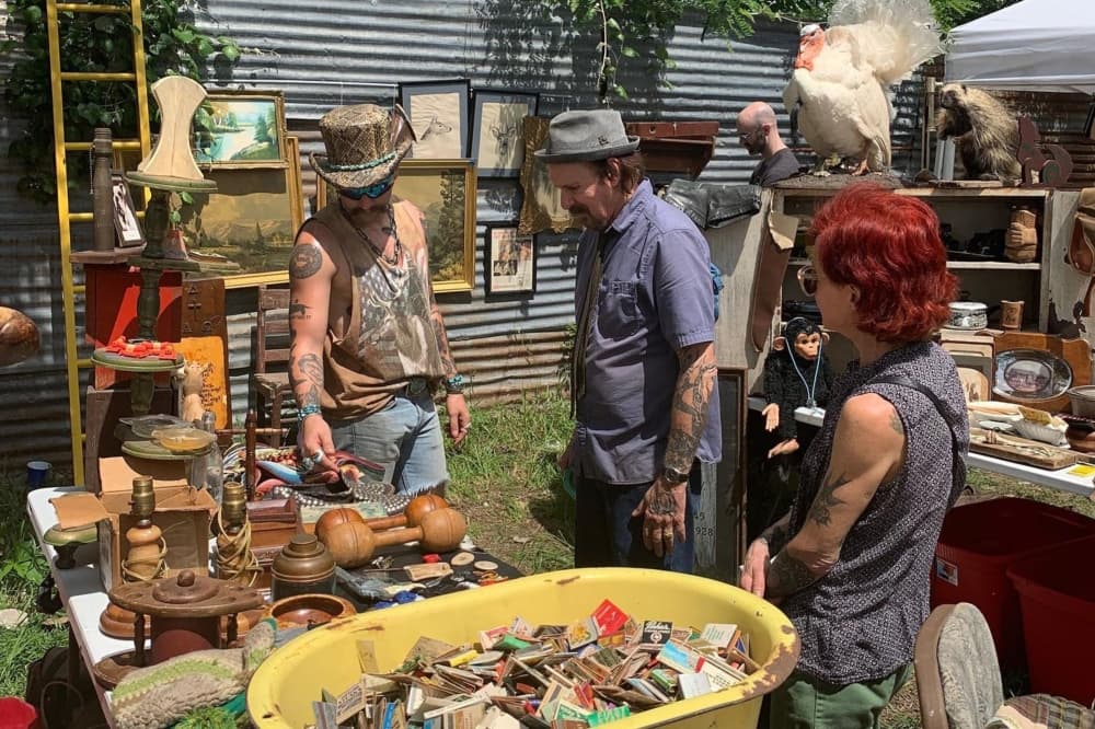 A photo of a vendor speaking to interested customers. 