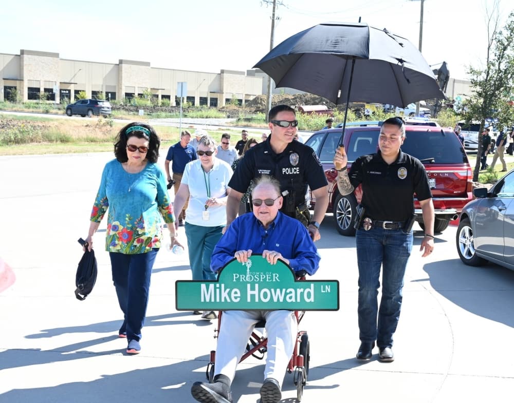 Mike Howard carrying his Mike Howard Lane sign