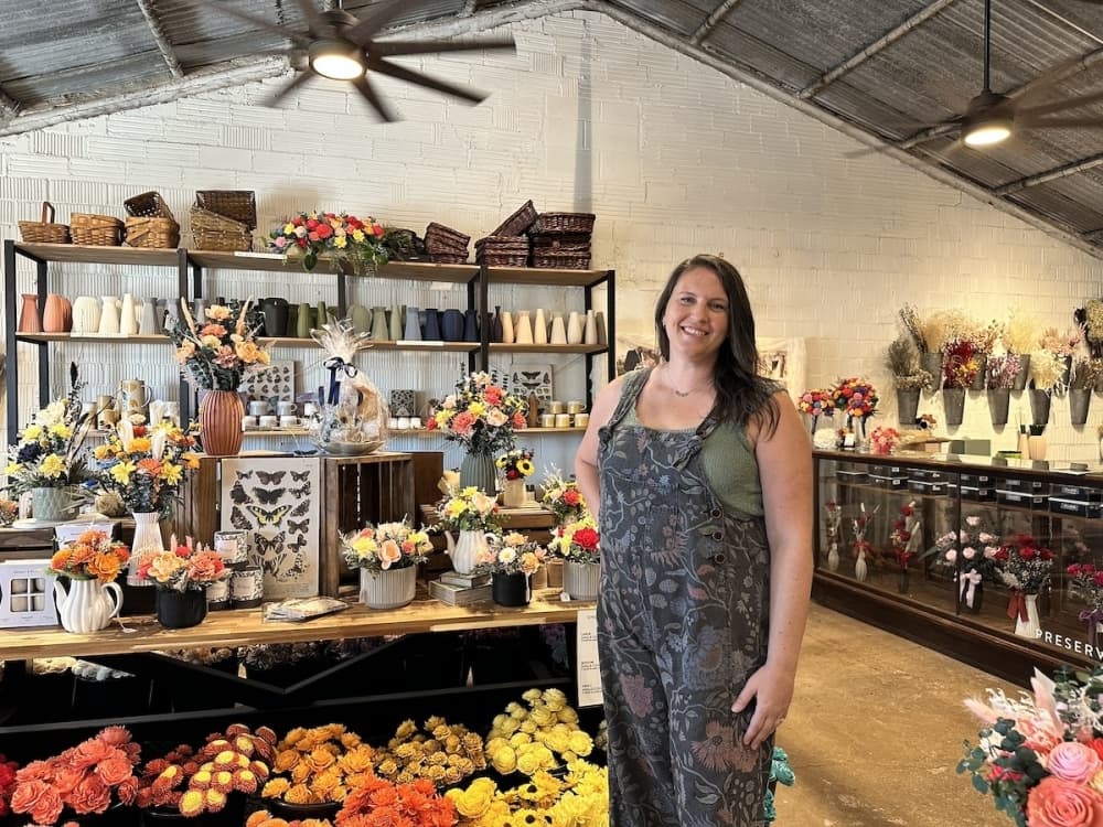 Photo shows flower shop owner.