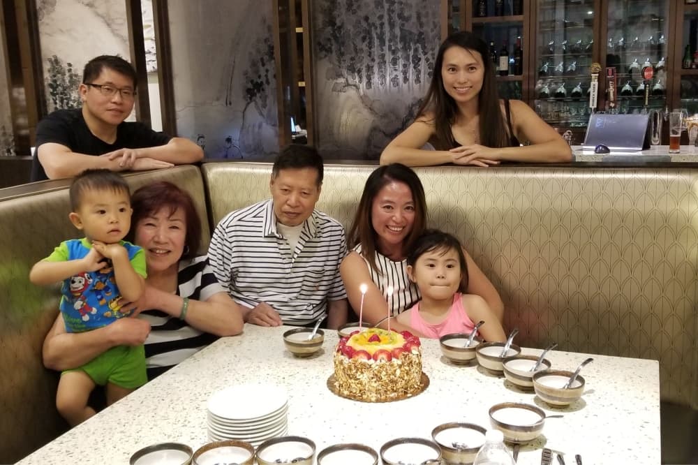 A photo of owners Amy and John Chen and their family in the restaurant. 