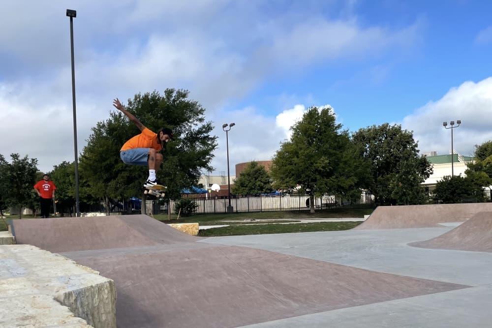 Skater does trick at skate park in the air 