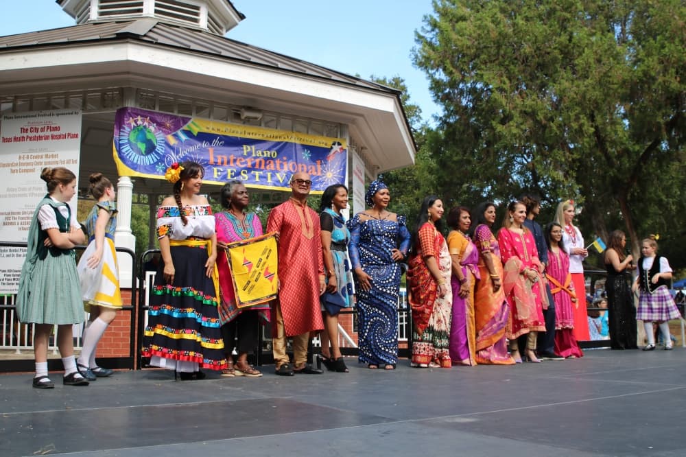 Group of males and females wearing international clothing. 