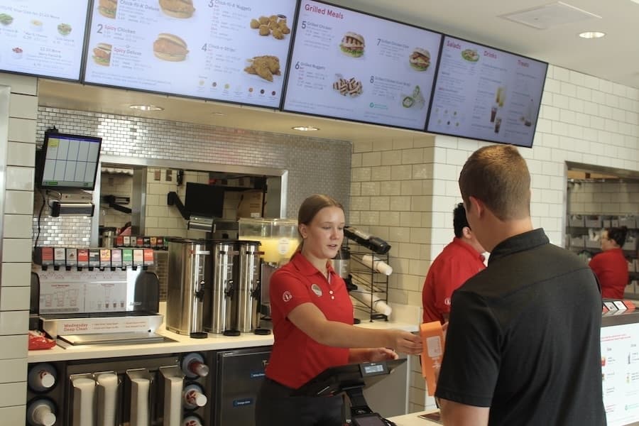 Picture of a woman helping a customer in a restaurant.