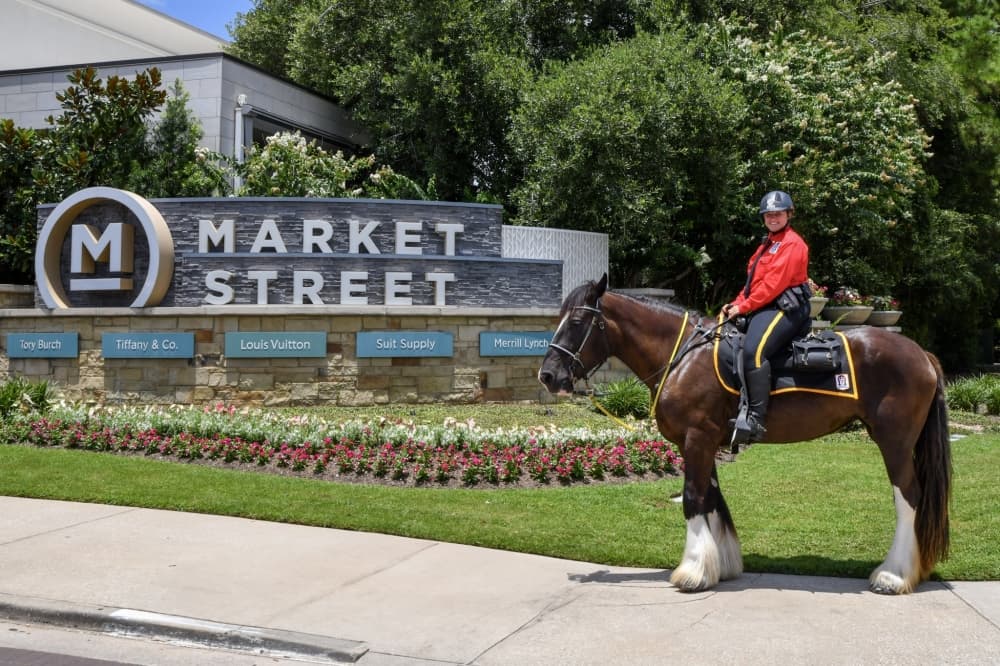 A mounted security officer by a Market Street sign