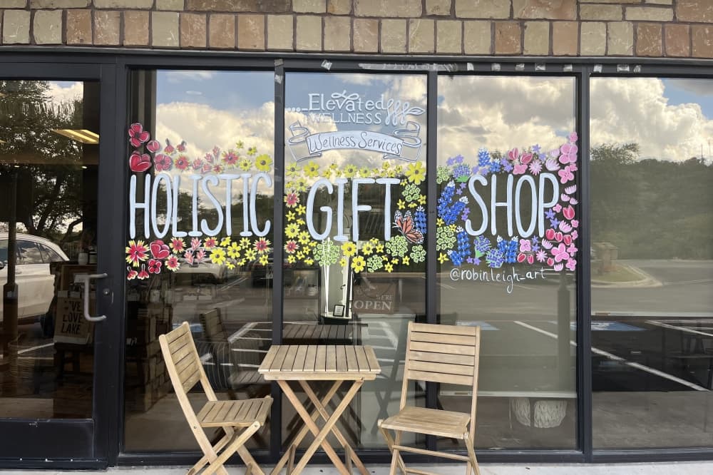 painted sign reading "holistic gift shop" 