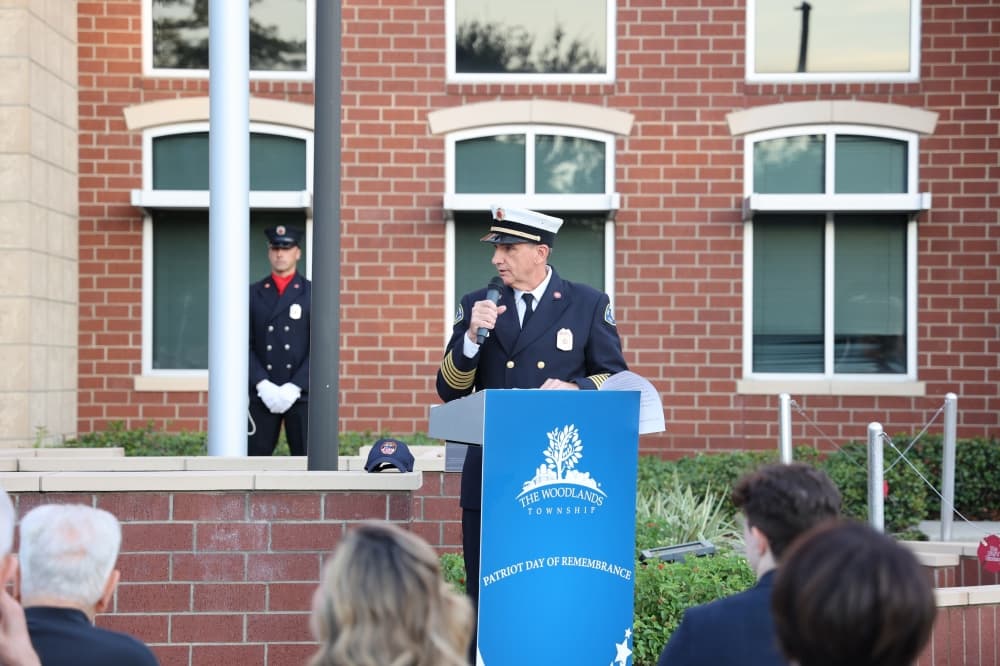 Uniformed man speaks at a podium