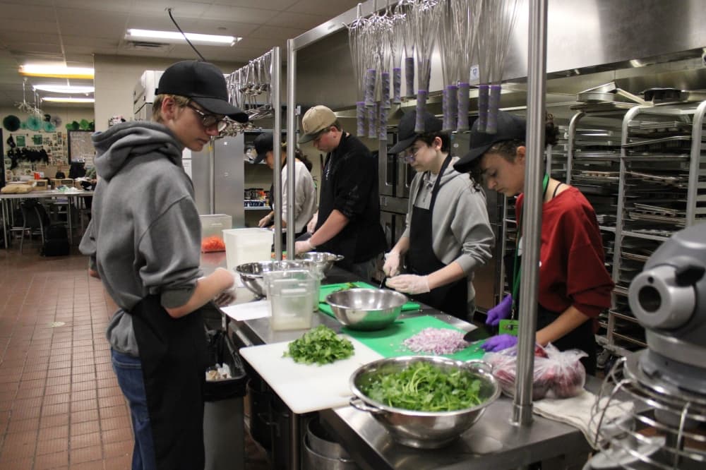 students chopping vegetables. 