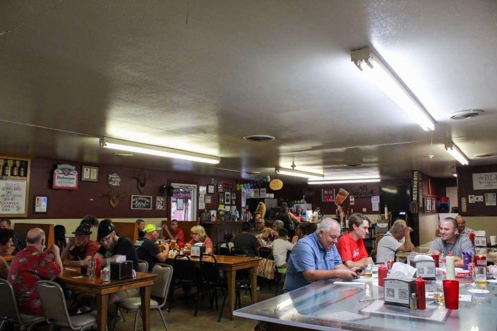 An image of the inside of the restaurant filled with customers. 