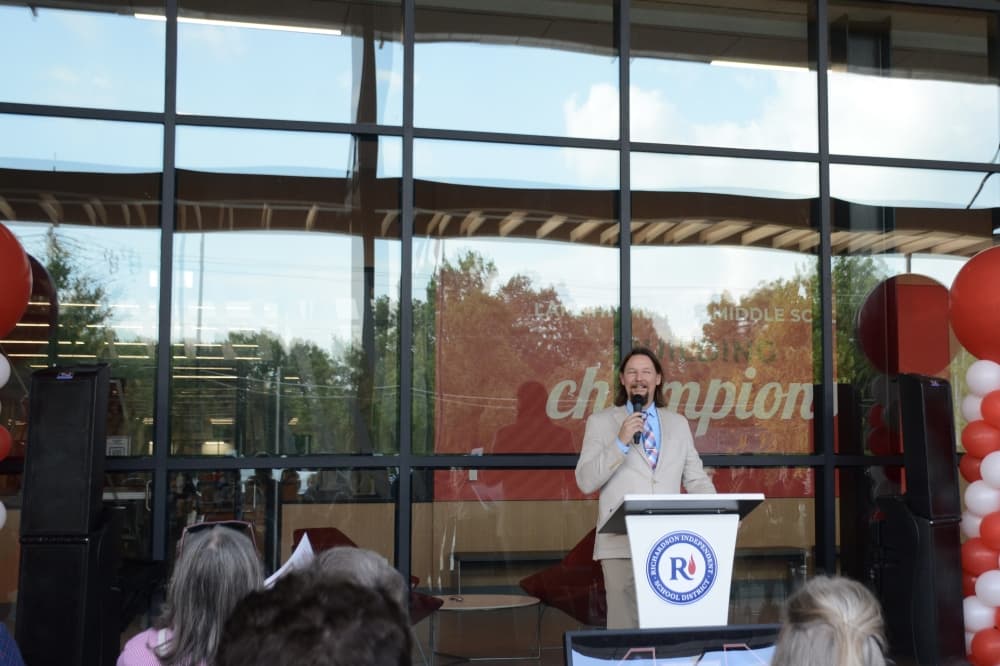 Lake Highlands Middle School Principal Nick Rustin addresses members of the public at a ribbon cutting ceremony. 