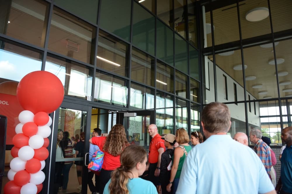 Members of the public walk into Lake Highlands Middle School after a ceremony Sept. 5. 