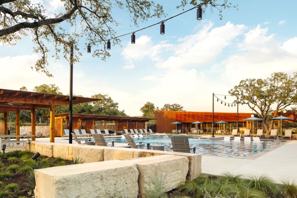 A pool and cabana area in a neighborhood. 