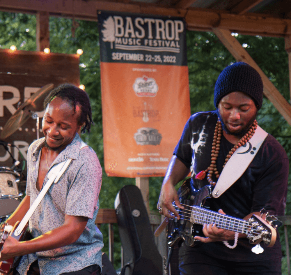 Two musicians play instruments during a previous festival.