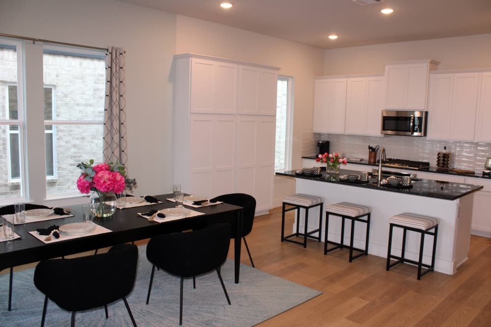 Kitchen and dining area with black and white color scheme.