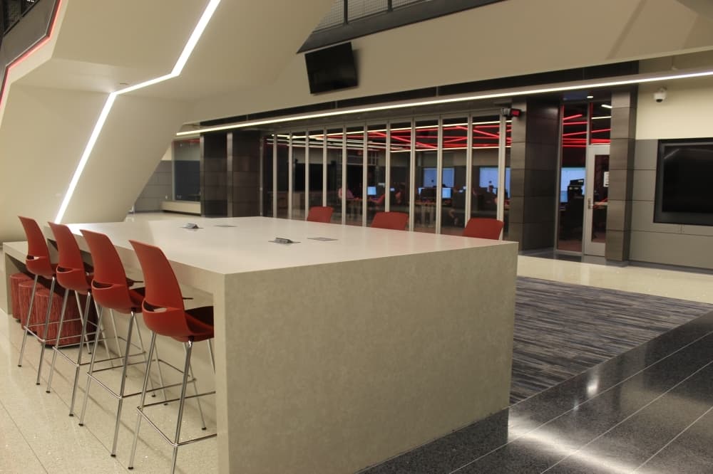 a learning space with a large desk and chairs 