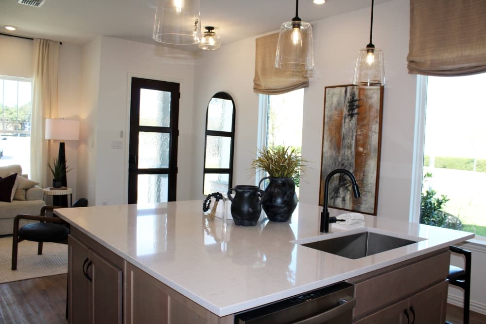 Interior of home from the viewpoint of the kitchen into the living area and front door. 