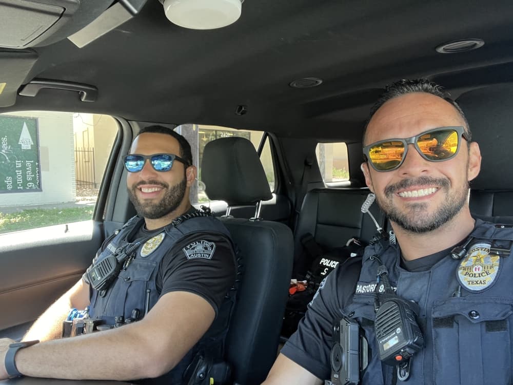 Jorge Pastore and Felix Perez in cop uniform/cop car 