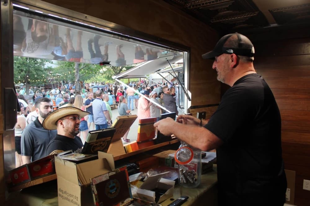 Ron Stevens selling cigars at an event. 