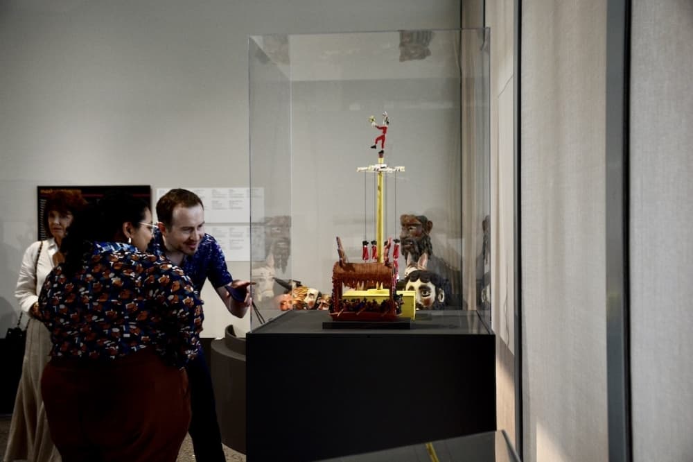 Individuals at the Crow Museum of Asian Art look at art within the Latin American gallery. 