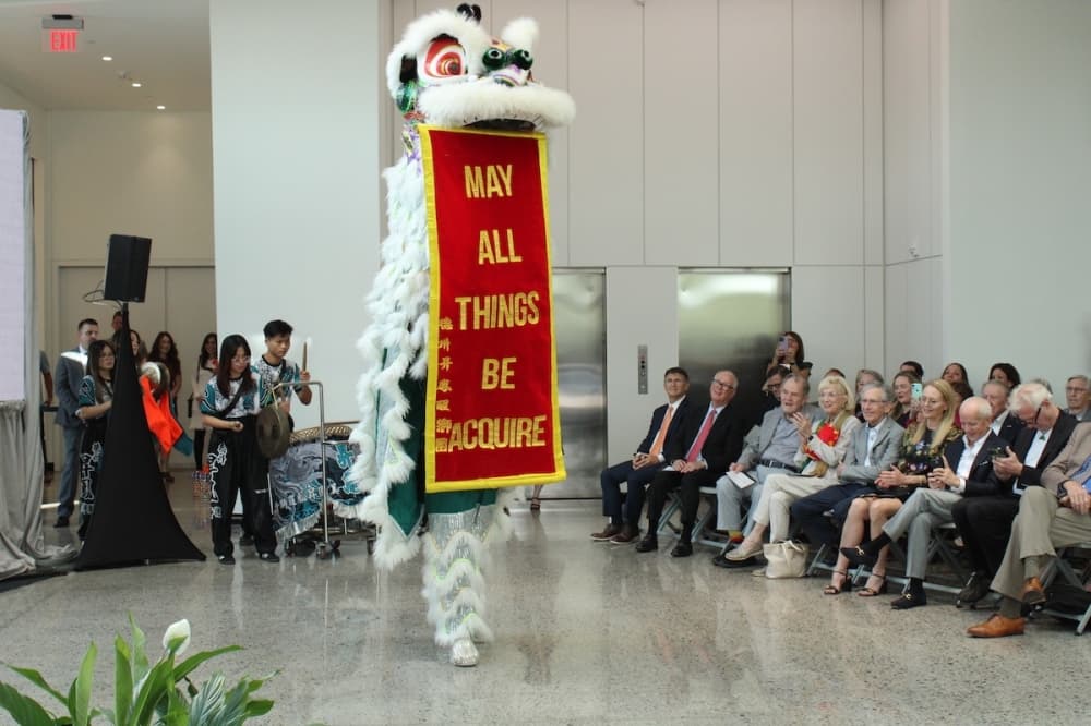 Attendees at a ribbon cutting and groundbreaking ceremony for the Atheneum witness an Asian art performance. (Dustin Butler/Community Impact)