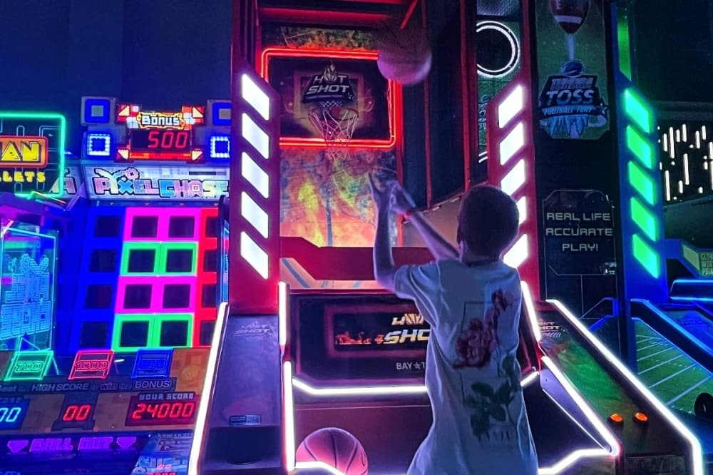 a teenager is shooting a basketball