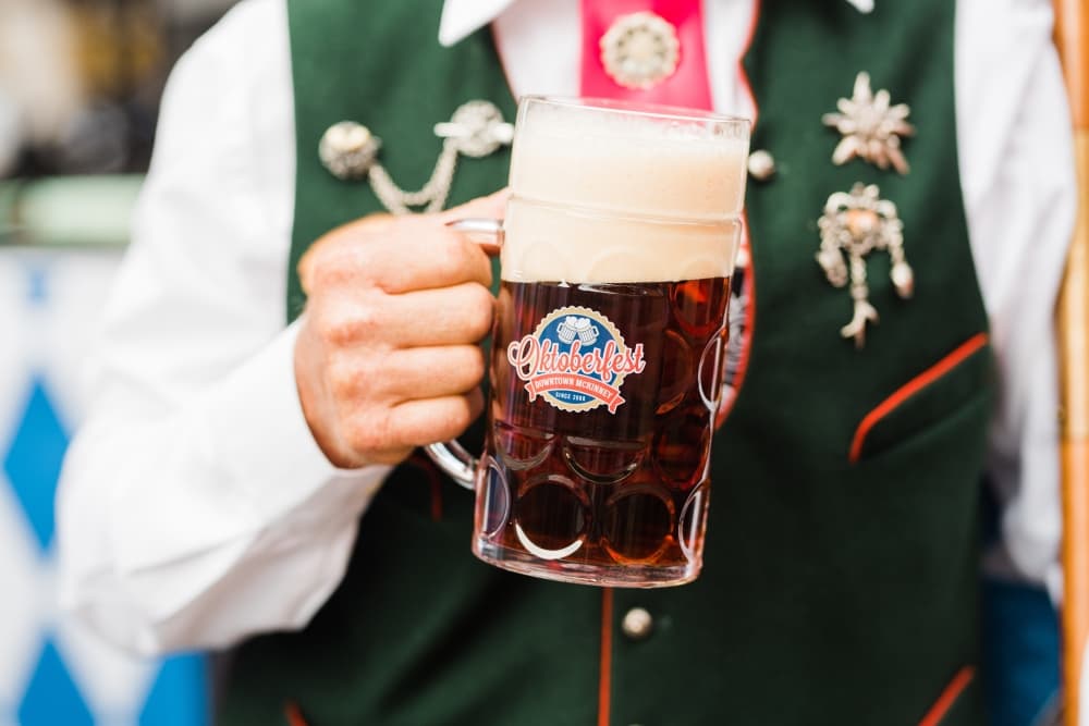 Hand holding a stein full of beer