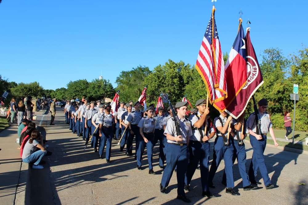 ROTC members marching in a parade.
