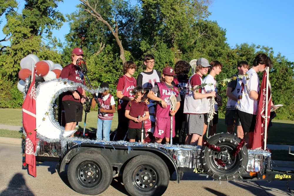 Teens on a float in a parade. 