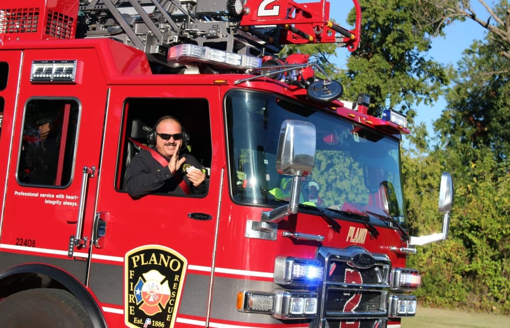 Close up of a fireman in a fire truck passenger seat. 