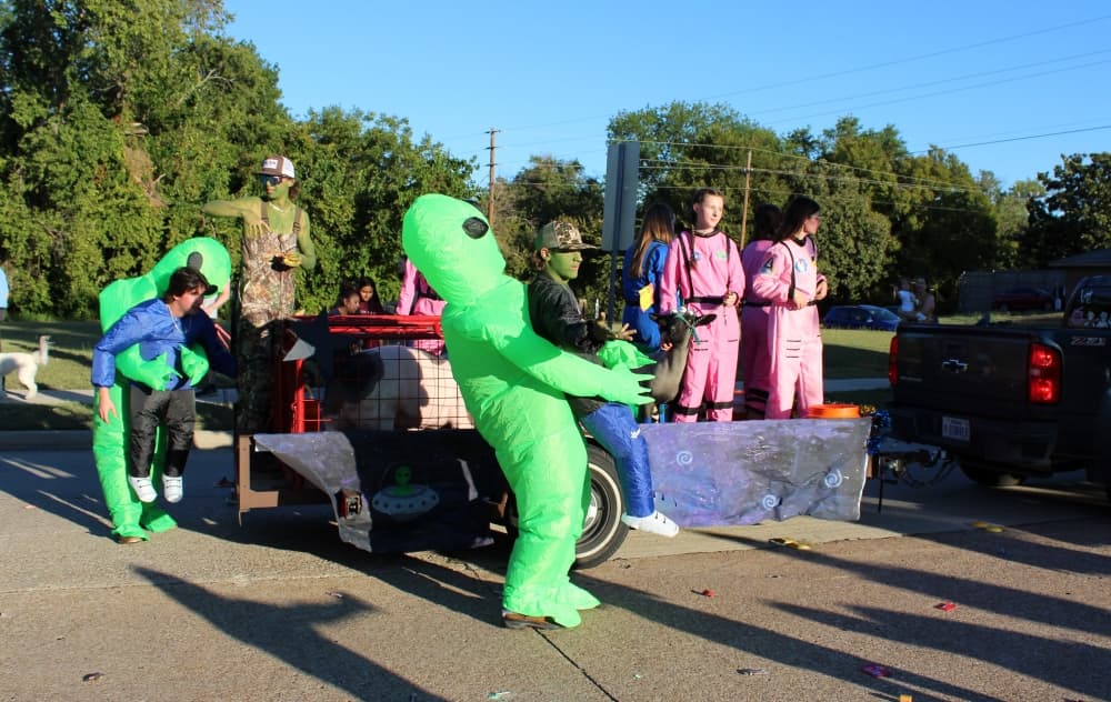 Teens on a float in a parade. 