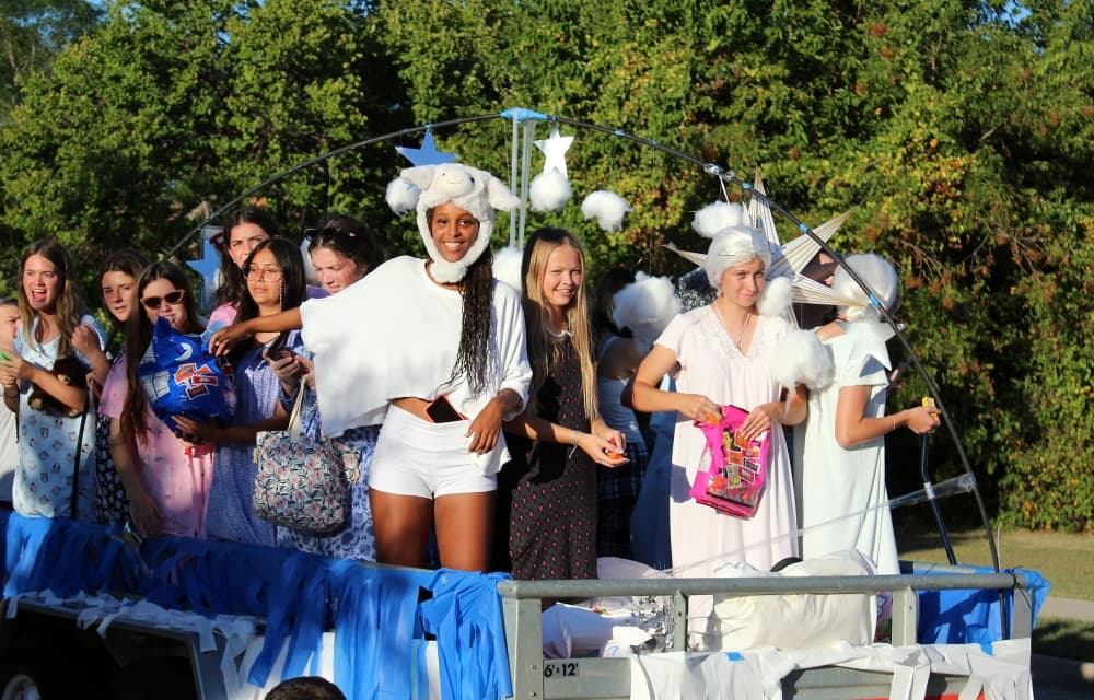 Teens on a float in a parade. 
