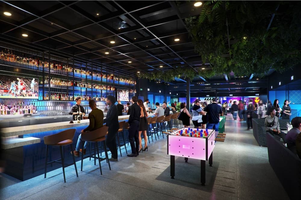 Rendering of a dark bar area with ambiance lighting and a foosball table. 