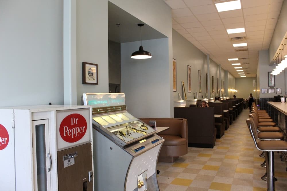 An image of the jukebox and Dr. Pepper machine inside the store. 